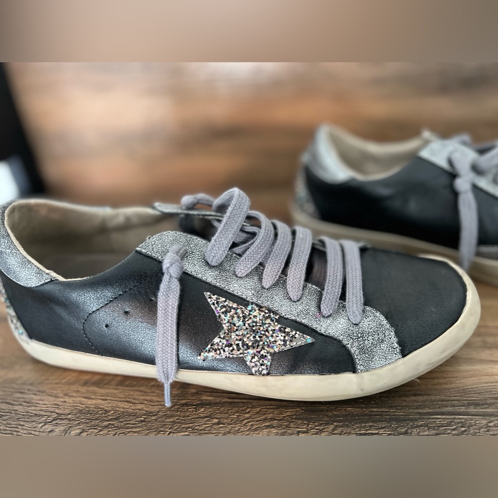 SHU SHOP black and grey leather star sneaks with glitter detail.
